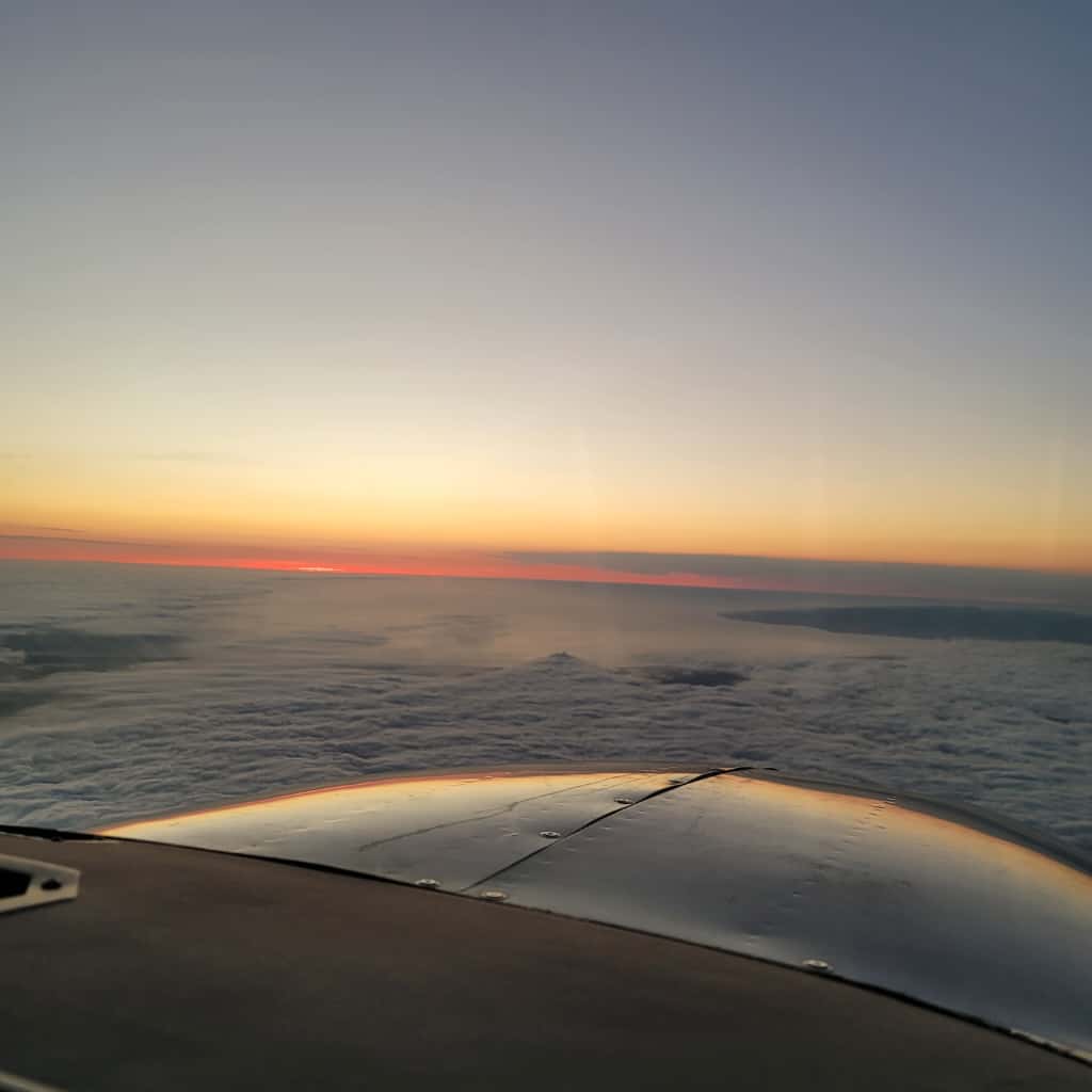 Sunset above the clouds from the cockpit
